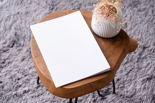 blank magazine mockup on coffee table with vase and grey rug