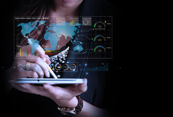 Businesswoman uses digital tablet looks at screen display showing infographics and global world map data. Global communication network concept.