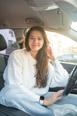 Portrait of young woman inside car interior. The car as a place in which a significant part of people lives passes