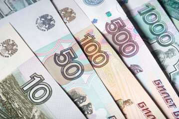 Russian rubles banknotes of different denominations close-up - obrazy, fototapety, plakaty