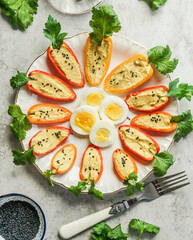 Fake carrots make with paprika, hummus and parsley served on plate with eggs, top view. Funny Easter food - 766895704