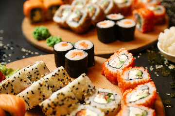 Assorted Sushi on Wooden Plates on Table