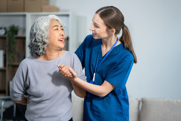 young caregiver assists her elderly woman patient at a nursing home. senior woman is assisted by a nurse at home.