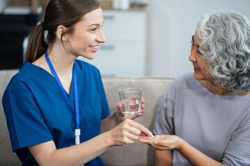 female therapist gives medication advice to an elderly patient.