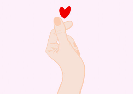 Hand of woman making heart shape with fingers against pink background