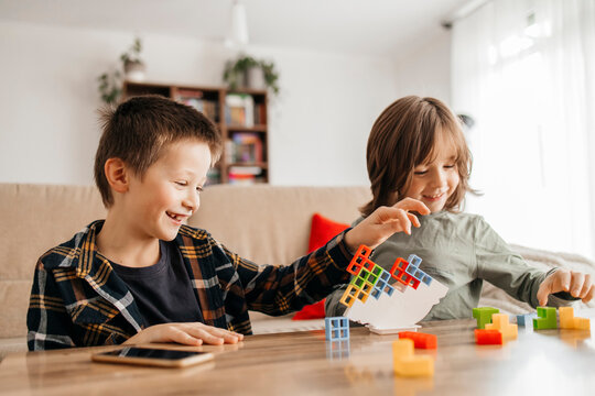 Happy boys playing balance game at home