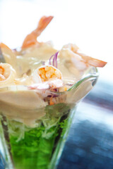 Glass with shrimp cocktail in white sauce