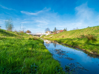 Fototapeta premium Pfaffenhofen Bürger Park with the Ilm as a little creek and blue sky background