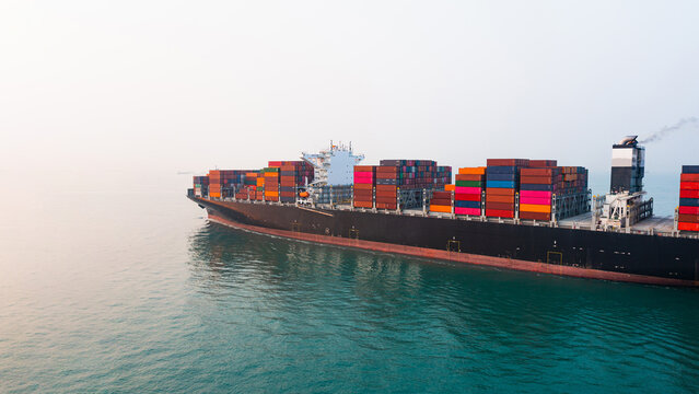 Aerial view Cargo container ship. Business logistic transpotransportation in the ocean ship carrying container,Cargo ship, Cargo container in factory harbor for import-export with copy space for text.
