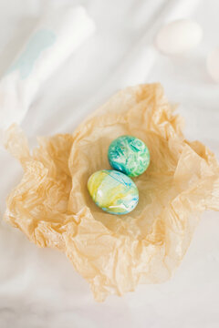 Pair of decorated Easter eggs in crumpled paper