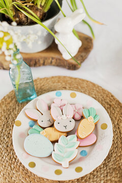 Easter cookies in plate over rattan on table