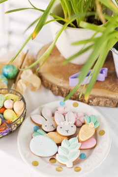 Easter cookies in plate with eggs on table