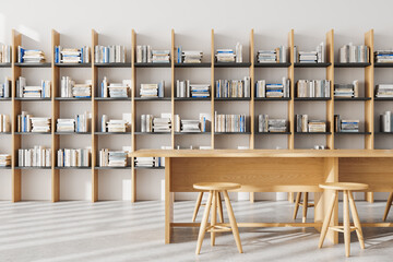 Modern library interior with bookshelf, reading space with desk and stool