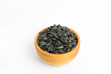 black sunflower seeds in a small wooden cup