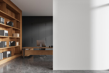 Gray and white CEO office interior with bookcase with blank wall