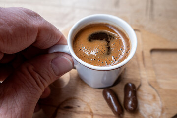 Istanbul, Turkey A cup of Turkish coffee and a hand.