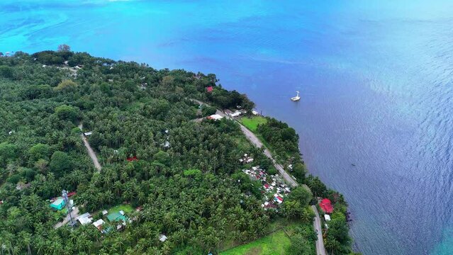 Drone shot approaching the emerging cross of the Sunken Cementery in Camiguin