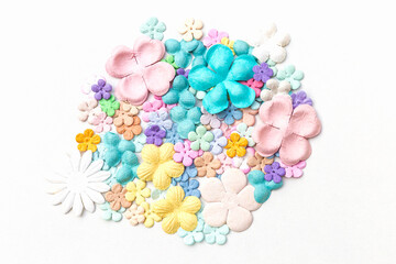 Pastel color paper flower arrange in round shape on white background, flower background