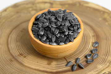 black sunflower seeds in a small wooden cup