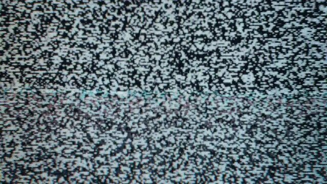 Close-up view of static noise on an old television screen. The static consists