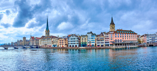 Panorama of the riverside housing of Limmat river with Peterskirche and Fraumunster churches, Zurich, Switzerland