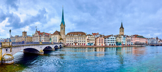 Panorama of the riverside housing of Limmat river with Peterskirche and Fraumunster churches, Zurich, Switzerland - obrazy, fototapety, plakaty