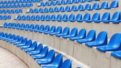 Plastic blue seats on street auditorium or stadium. No people, side view, perspective