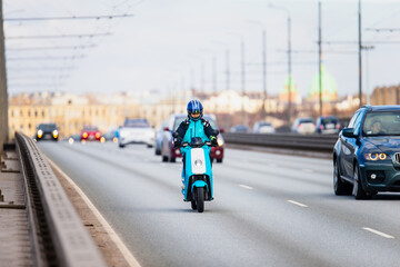 Fototapeta na wymiar Blue electric scooter driving on the highway
