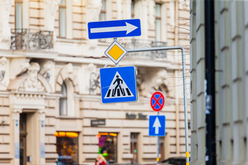 Different direction road signs in the streets of Riga, Latvia showing the way for pedestrians