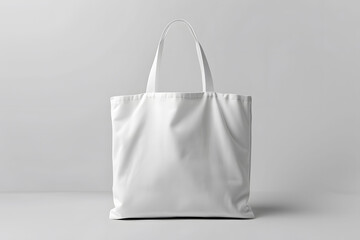 Blank white tote bag mockup isolated on a grey background with realistic texture