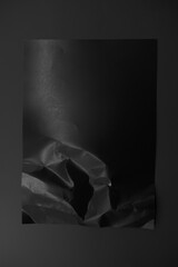 Black crumpled paper isolated on black background