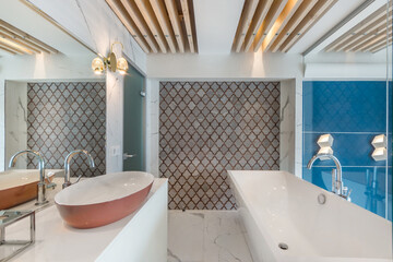 Bathroom with original decor. A large mirror over the sink bowl.