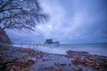 wooden fishing piers lying on the sea of Marmara cloudy weather sunset hours while the waves hit...