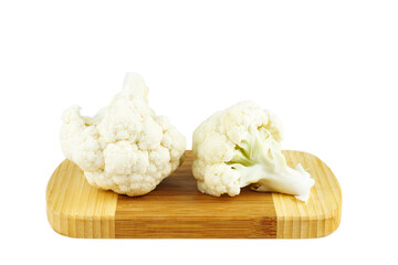 Cauliflower pieces on wooden cutting board isolated on white background