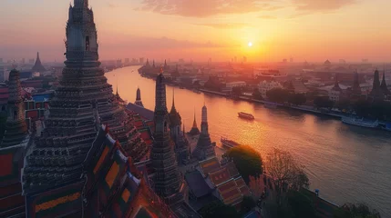 Dekokissen A panoramic view of Wat Arun temple at sunset in Bangkok, Thailand with the river and city in the background © Kien