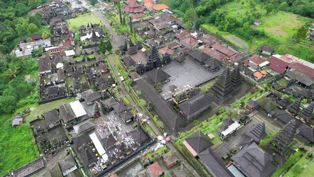 Tilt down drone footage of Pura Agung Besakih hindu temple on cloudy day. Bali, Indonesia.
