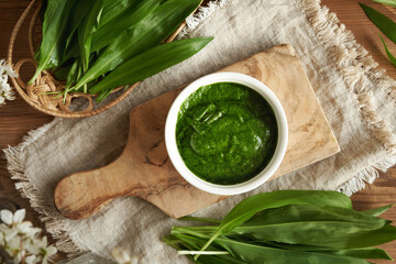 Homemade green pesto sauce made of fresh bear's garlic or ramson leaves - wild edible plant...