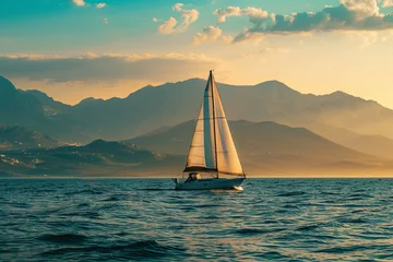 Foto op Canvas Sailboat in the ocean under the evening sunlight with a beautiful mountainous backdrop © Emanuel