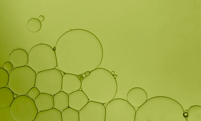Oil serum droplets pattern background. Abstract green background.