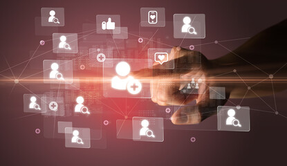 Hand pressing social media multimedia application screen with media icons on futuristic concept