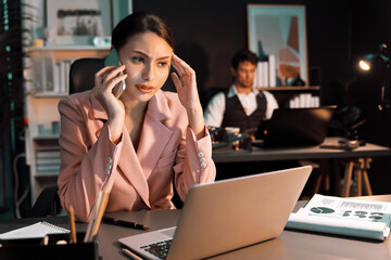Focusing woman calling to customer working at front desk view while waiting email business project...