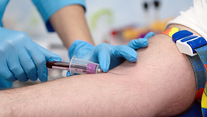 A female doctor takes a plasma sample from a patient to treat patients. Clinical studies, donation...