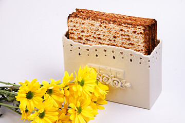 Passover background with matzah and white and purple gerberas. Jewish holiday. View from above. Passover Passover Seder Passover celebration concept. Passover.
