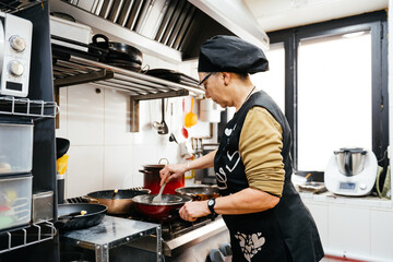 Female Chef Prepares Meal in a Bright Professional Kitchen During a Busy Workday