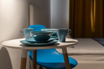 a table set for a romantic dinner with ceramic plates and cups
