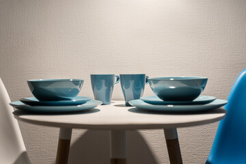 a table set for a romantic dinner with ceramic plates and cups