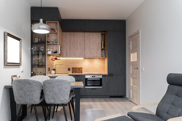 large modern grey kitchen with wooden furniture and appliances