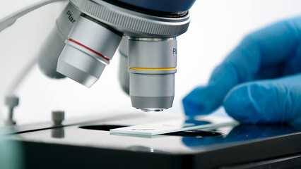 Using a high-tech microscope, scientists examine the sample in a modern industrial laboratory. Science and technology. Tests. Medical experiment.