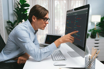 IT developer selecting by point on coding online software development information on pc comparing...