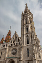 Fototapeta na wymiar Famous historic Matthias Church in Budapest, Hungary, a must-visit landmark. Gothic architectural and decorative colorful powerful style, Catholic church with neo-Gothic style, built in 1255